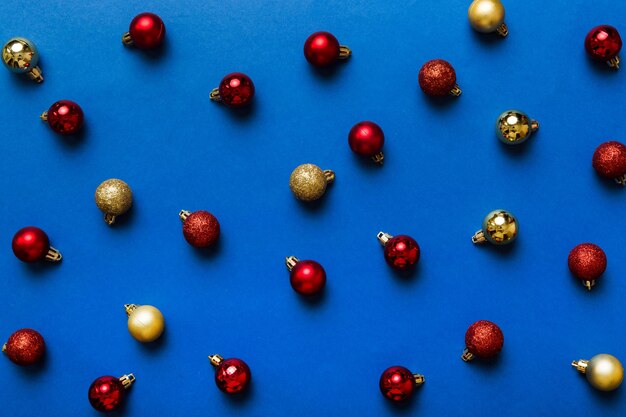Christmas composition a pattern of christmas balls on colored background Flat lay top view New year decor