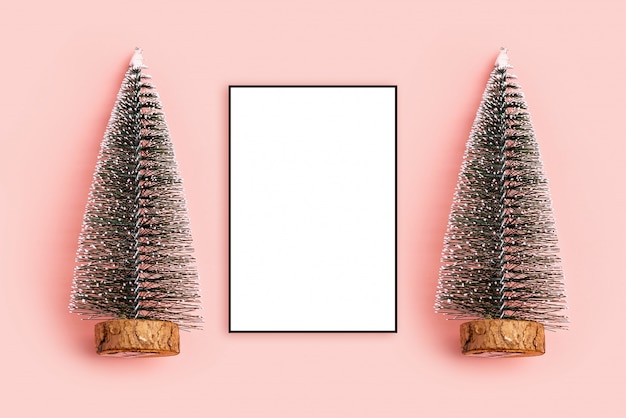 Photo christmas composition. photo frame, pine christmas tree pastel pink background top view, c