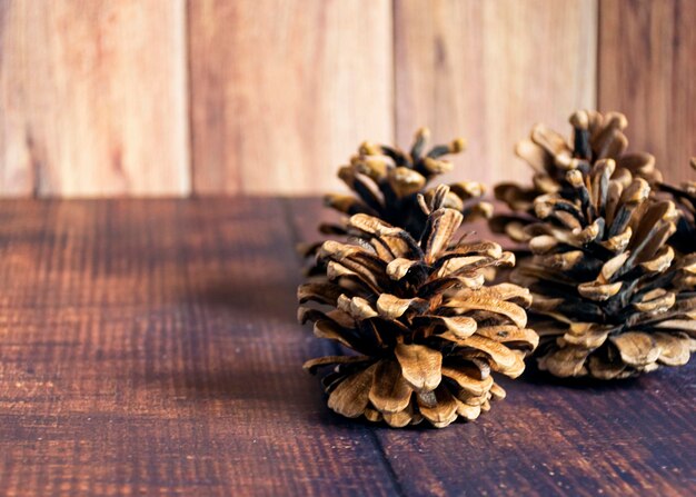 크리스마스 컴포지션 소나무 콘은 화환 플랫이 있는 소박한 빈티지 나무 배경에 평면도 복사 공간이 있습니다.
