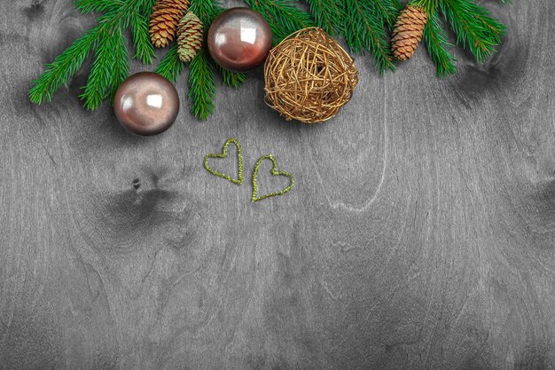 Christmas composition for postcard, cover, banner. Fir branches and balls, cone on rustic wood. new year concept. Close up, copy space for text.