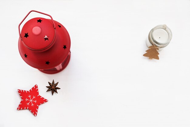 Christmas composition. Red decorations on white background. Christmas candlestick