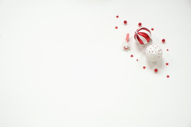 Christmas composition - red decorations on white background, minimalism