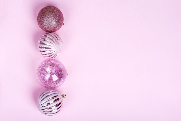 Christmas composition. Set of christmas pink decorations, shiny balls on pastel background