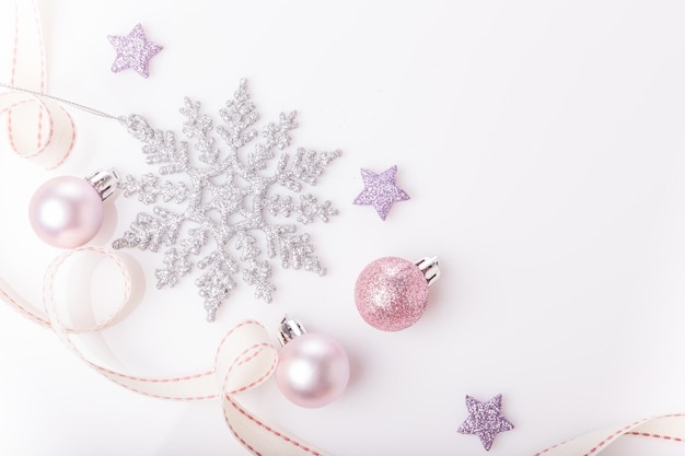 Christmas composition Spruce branches xmas tree xmas pink decor holiday ball with ribbon on white background