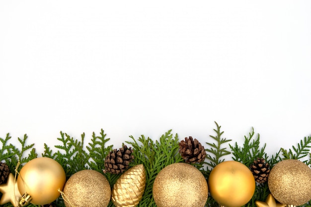 Christmas composition on a white sheet with a Christmas tree balls and cones