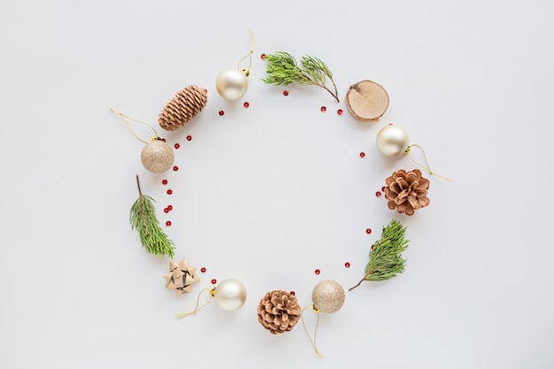 Christmas composition with baubles, fir branches on white. new year concept