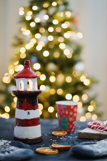 Christmas composition with decorations by a background of christmas tree with garland