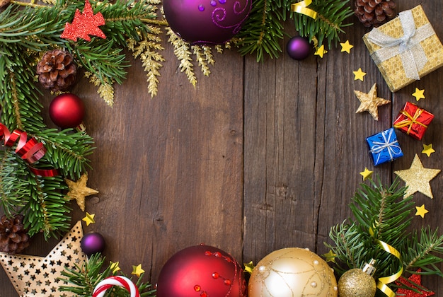 Christmas composition with decorations and paper on wood, top view with copy space