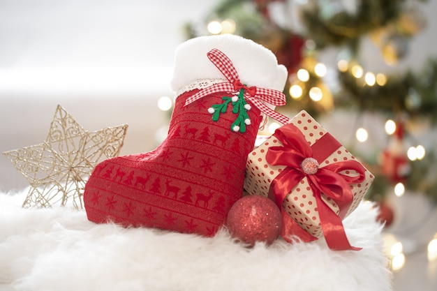 Christmas composition with a decorative sock and gift box in a cozy home atmosphere