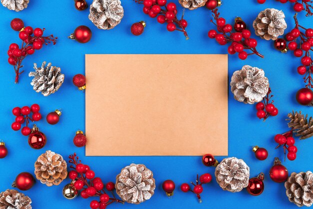 Christmas composition with empty sheet of  paper in the center