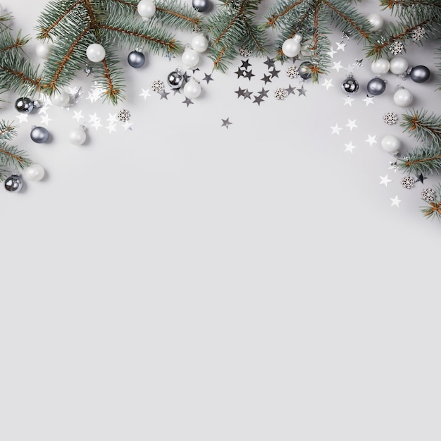 Christmas composition with fir branches tree, silver balls on grey . Merry Xmas card. Winter holiday. .