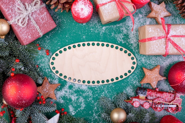 Рождественская композиция с еловыми ветками, игрушками и подарочными коробками