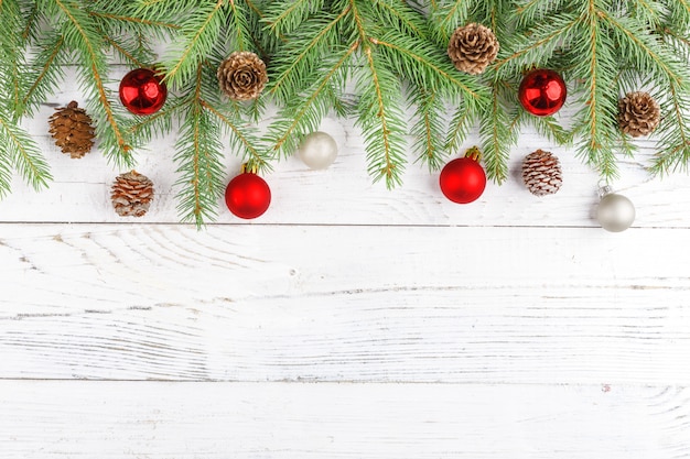 Christmas composition with frame of fir branches, Christmas decorations and pine cones. Flat lay, top view