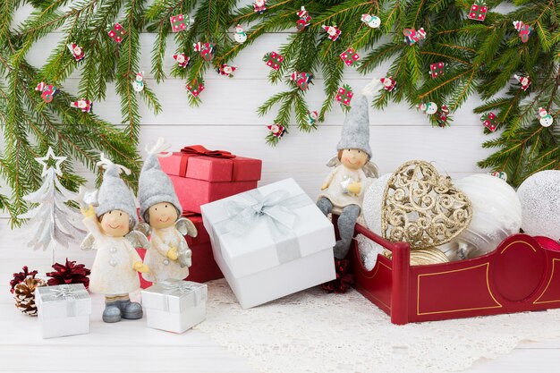 Christmas composition with gift box, Christmas fir tree, angels