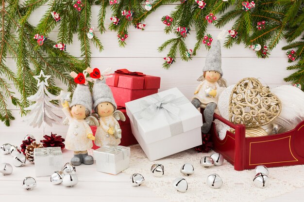 Christmas composition with gift boxes, angels, Christmas fir tree