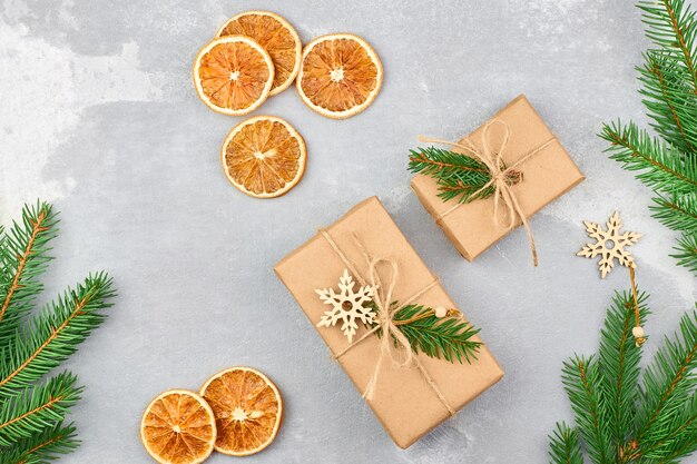 Christmas composition with gift boxes, dry oranges and fir tree branches