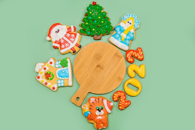 Photo christmas composition with gingerbread colorful cookies on the green background flat lay copyspace