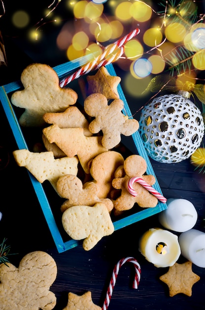 Christmas composition with gingerbread and gift on wooden table