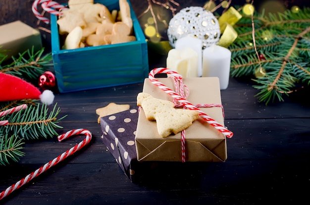 Christmas composition with gingerbread and gift on wooden table