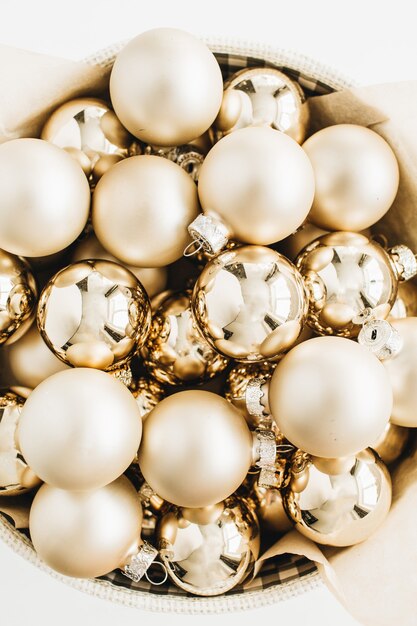 Christmas composition with golden decoration balls on white surface.  top view