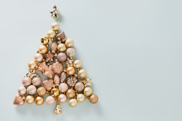 Christmas composition with golden shiny baubles in shape of tree