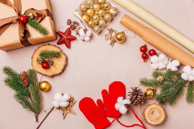 Christmas composition with handmade present box fir branch and decorations on gray background Top view with copy space