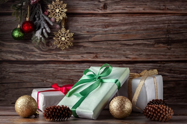 Christmas composition with small gifts, ribbons, Christmas balls and fir branch