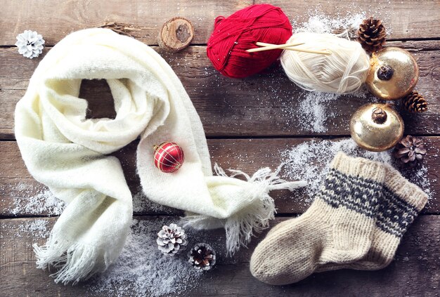 Christmas composition with socks, scarf and decorations on a wooden table