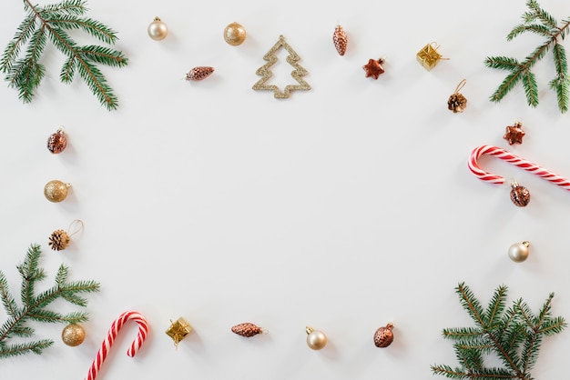 Christmas composition with spruce branches, gold elements and candy cane