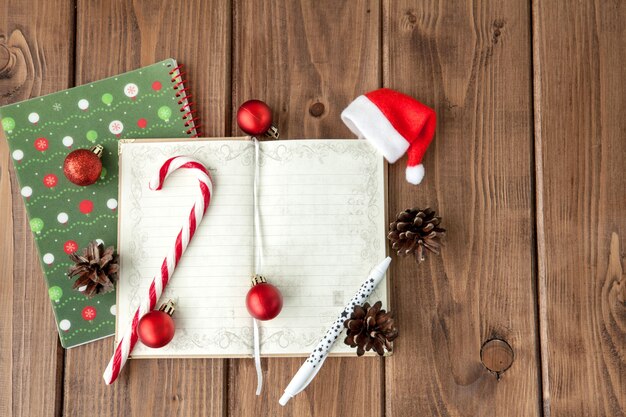 Christmas composition on a wooden table with notebook with plans for the year.