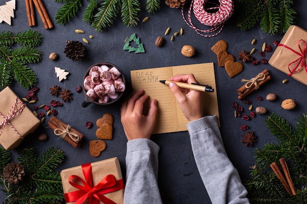 Christmas concept child hands writing letter to santa claus