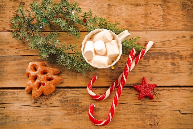 Christmas concept. Cup of hot chocolate with marshmallow and decorations on wooden table