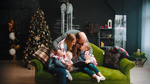 Christmas concept happy successful family sitting on the couch