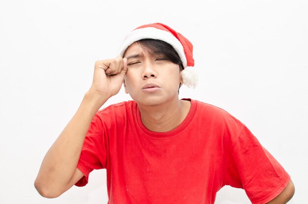 christmas concept man in red santa claus clothes with sad expression wiping the tears