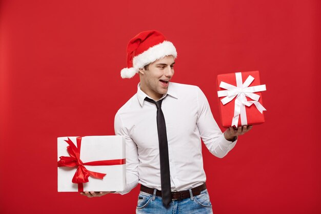 Christmas concept - portrait happy santa christmas businessman exciting with his gift over red background person