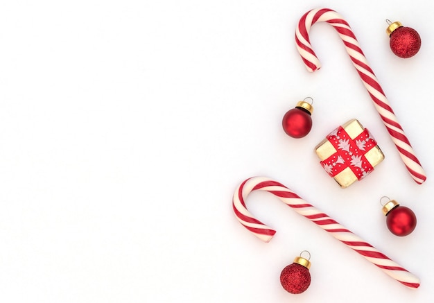 Christmas concept with candy canes, wrapped gift box with red ribbon and red Xmas balls