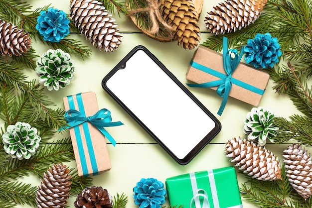 Christmas concept with fir branches with the phone to your advertising.