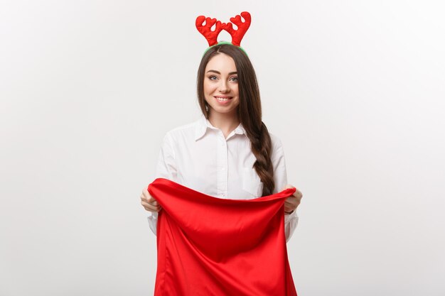 Christmas Concept - Young beautiful business woman excite with present in santa bag.