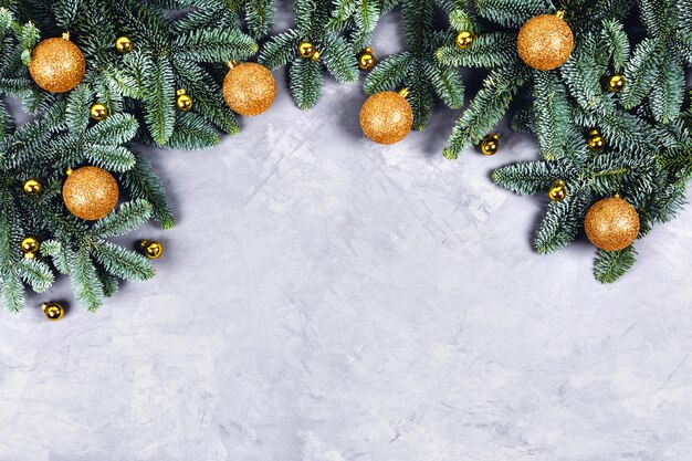 Christmas concrete table with fir tree and golden toys.