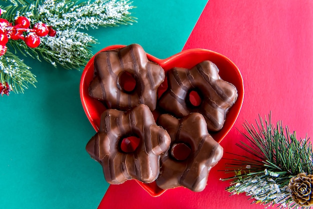 Christmas cookie or gingerbread on red and green background.