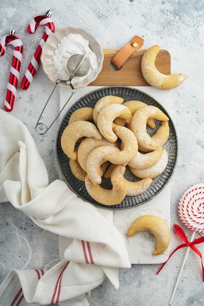 Christmas cookies crescents Homemade traditional Christmas cookies Vanilla crescents in rustic plate with christmas decorations on gray old background Food pattern Holiday baking concept