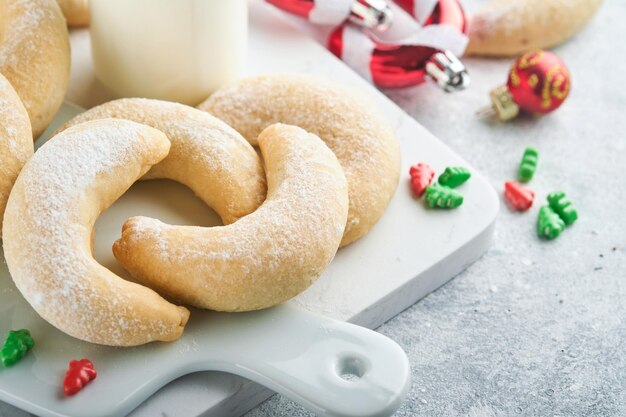 Christmas cookies crescents Homemade traditional Christmas cookies Vanilla crescents in rustic plate with christmas decorations on gray old background Food pattern Holiday baking concept