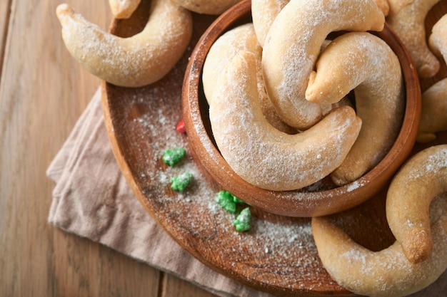 Christmas cookies crescents homemade traditional christmas\
cookies vanilla crescents in rustic plate with christmas\
decorations on old wooden rustic background food pattern holiday\
baking concept