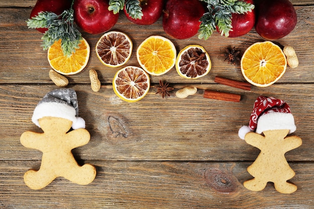 Christmas cookies and fruits on wooden table