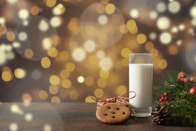 Christmas cookies and milk for Santa Claus in glass near Xmas tree. Christmas card.