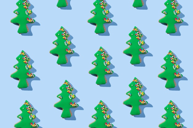 Christmas cookies seamless pattern of Christmas tree shape cookie on blue background Winter holidays dessert ornament