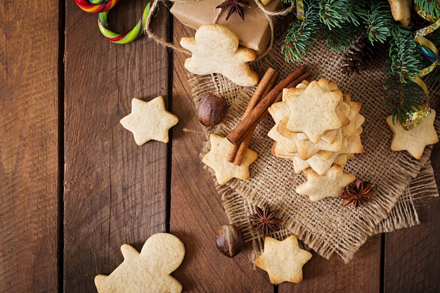 Christmas cookies and tinsel on a wooden table