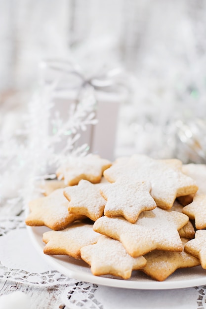 Christmas cookies and tinsel on a wooden table