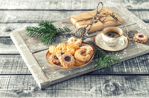 Christmas cookies with coffee and decoration. Vintage toned picture