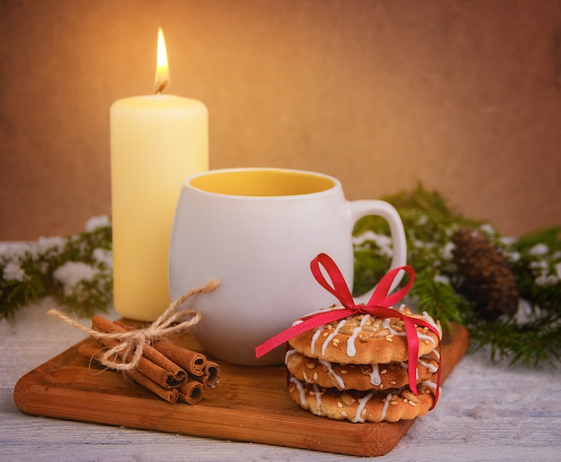 Christmas cookies with cup of tea on wooden table. Christmas decoration.